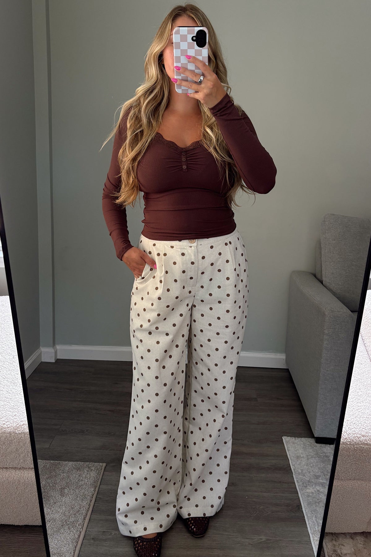 Margot high-waisted polka dot trousers with front pleats and side pockets styled with a brown long sleeve top