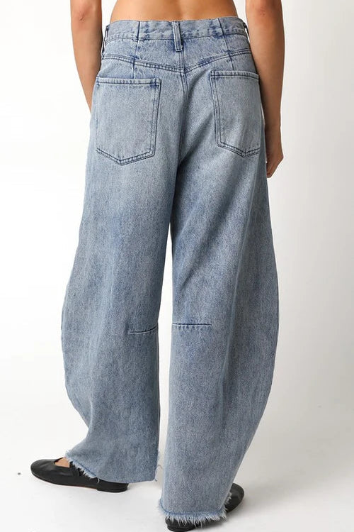 Light blue jeans worn by a person on a white background