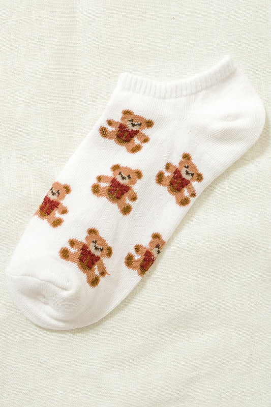 White ankle sock with teddy bear designs on a beige background