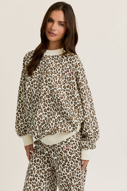 Woman wearing a leopard print outfit on a beige background