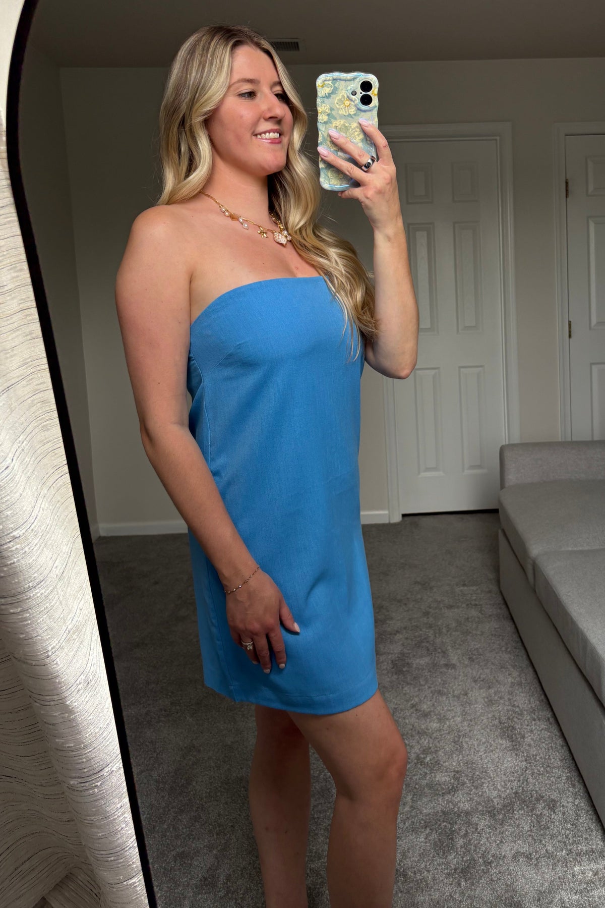 Side mirror view of the Santorini blue strapless mini dress showing its straight silhouette and mini length.


