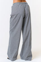 Back view of black-and-white gingham boxer pants showing the gathered waistband and relaxed wide legs.


