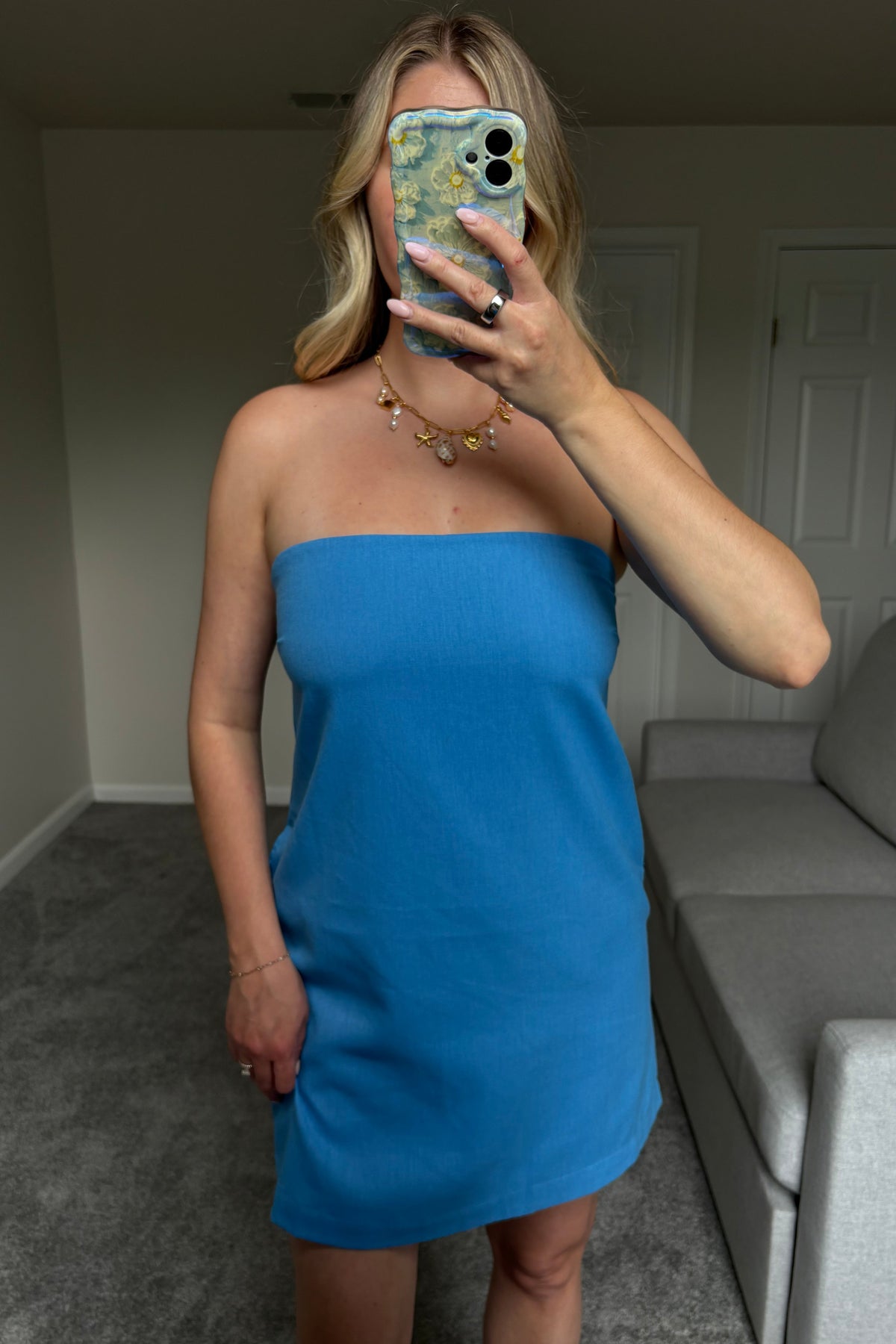 Straight-on mirror view of the Santorini blue mini dress showing its strapless neckline and above-the-knee hem.

