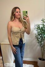 Angled view of the Carli beige tank top showing thin straps, shaped seams, and a sweetheart neckline.

