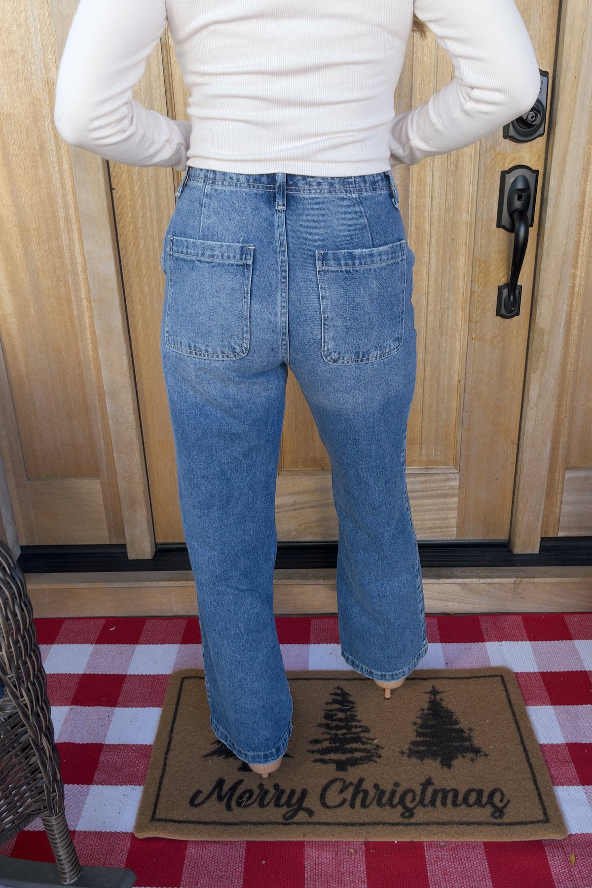 Back view of Sterling medium-wash jeans showing two patch pockets and wide legs.

