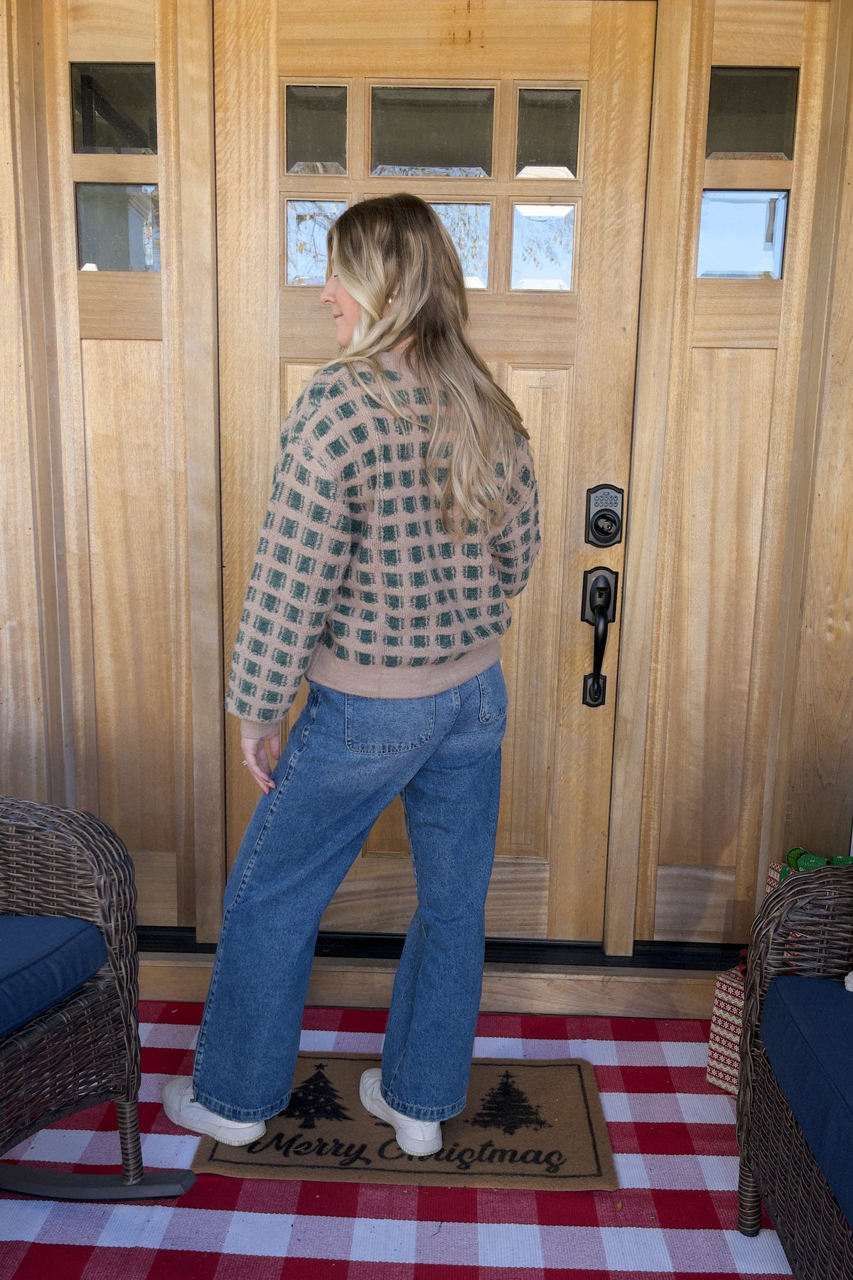 Back view of the Paige cardigan showing the checkered knit pattern and ribbed hem.

