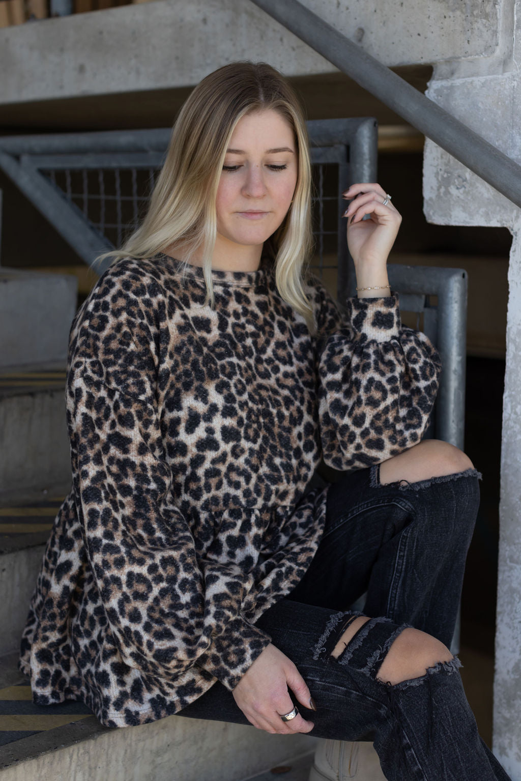 Close-up of the Bianca leopard print top showing its crew neckline, gathered waist, and bubble sleeves.

