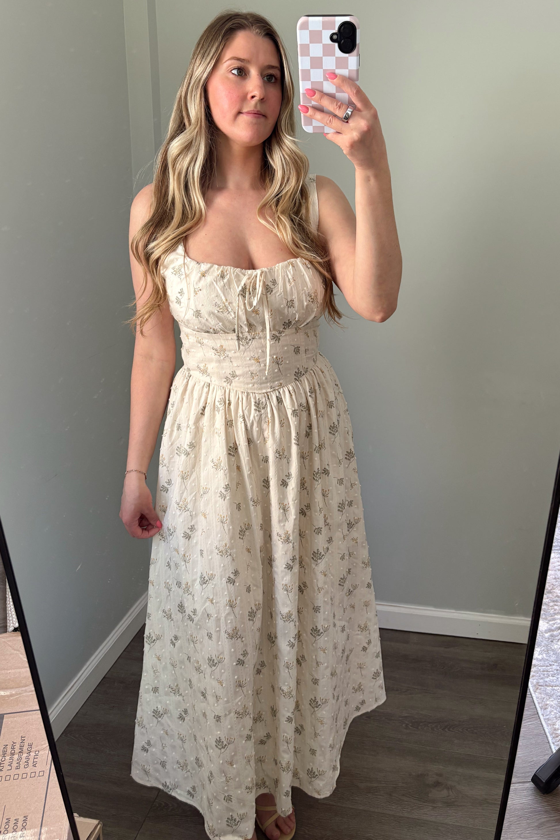 person wearing a floral embroidered maxi dress in a mirror photo
