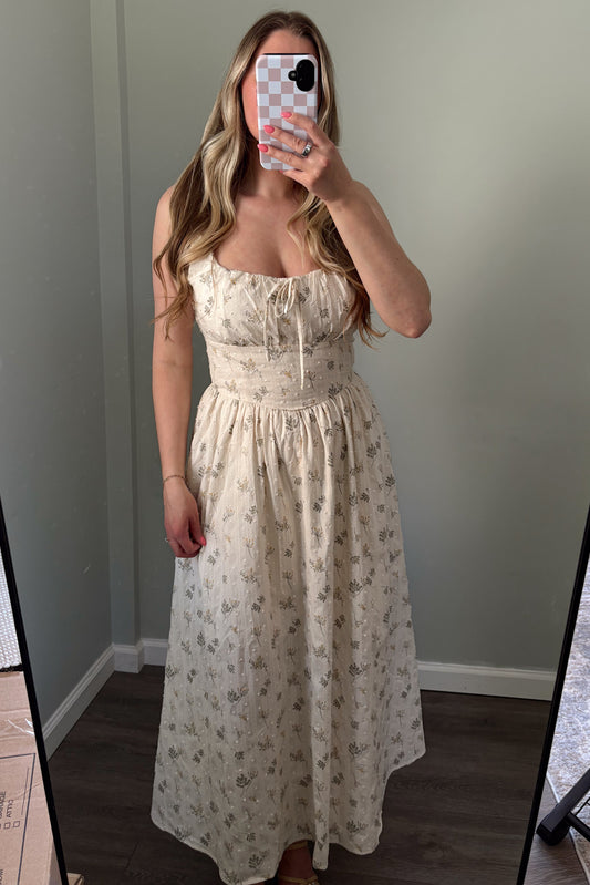 person wearing a floral embroidered maxi dress in a mirror photo
