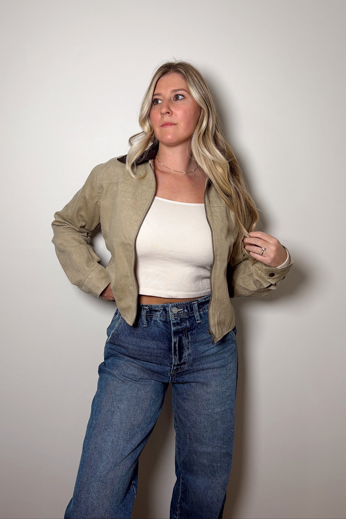 Emery khaki canvas jacket showing its contrast corduroy collar and snap-button cuff, worn open with denim.

