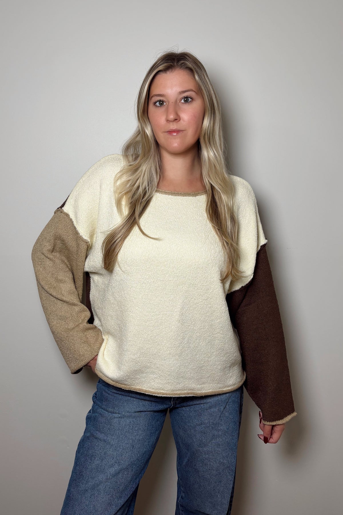 Front view of Brown Sugar colorblock sweater showing the round neckline and rolled hem
