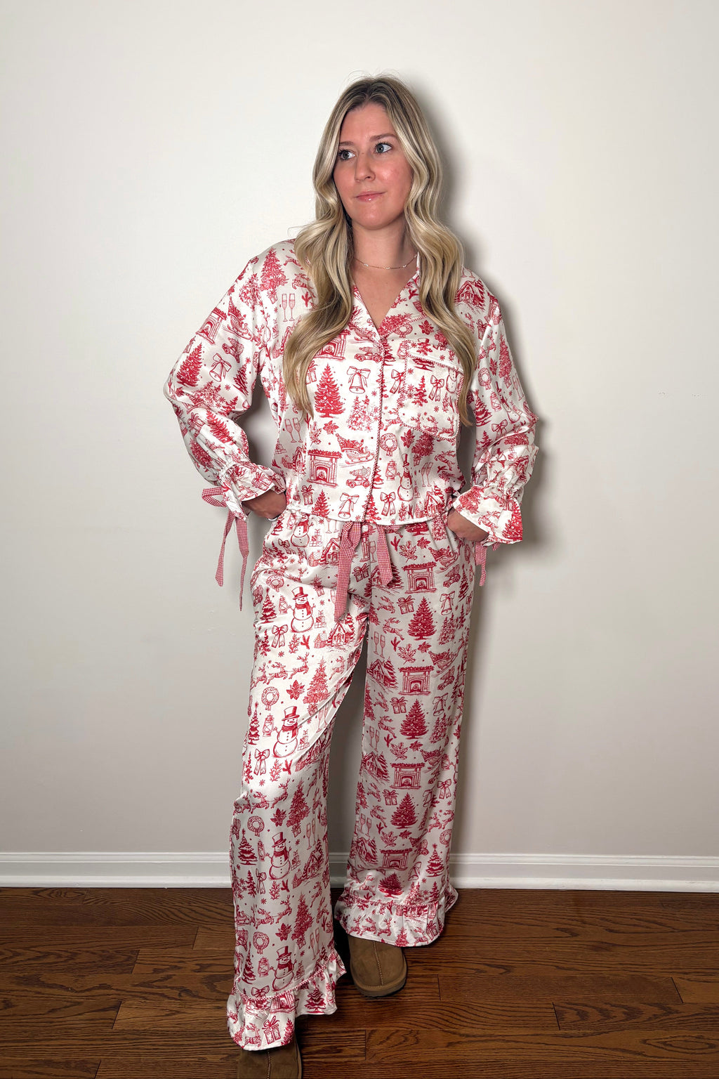 Woman wearing a red and white patterned pajama set against a plain background