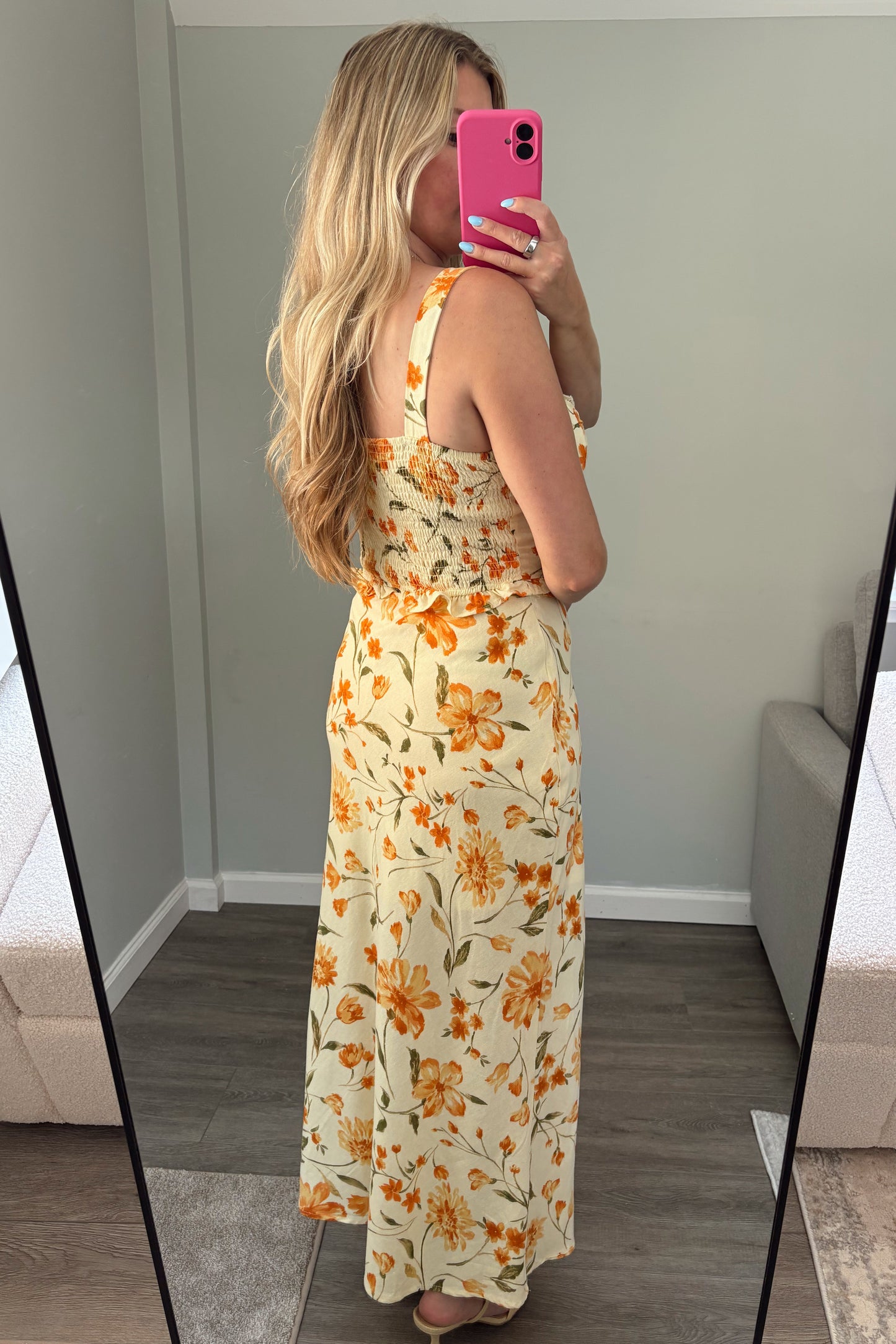 Person wearing a floral set standing in front of a mirror.