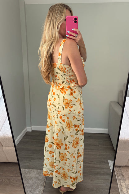 Person wearing a floral set standing in front of a mirror.