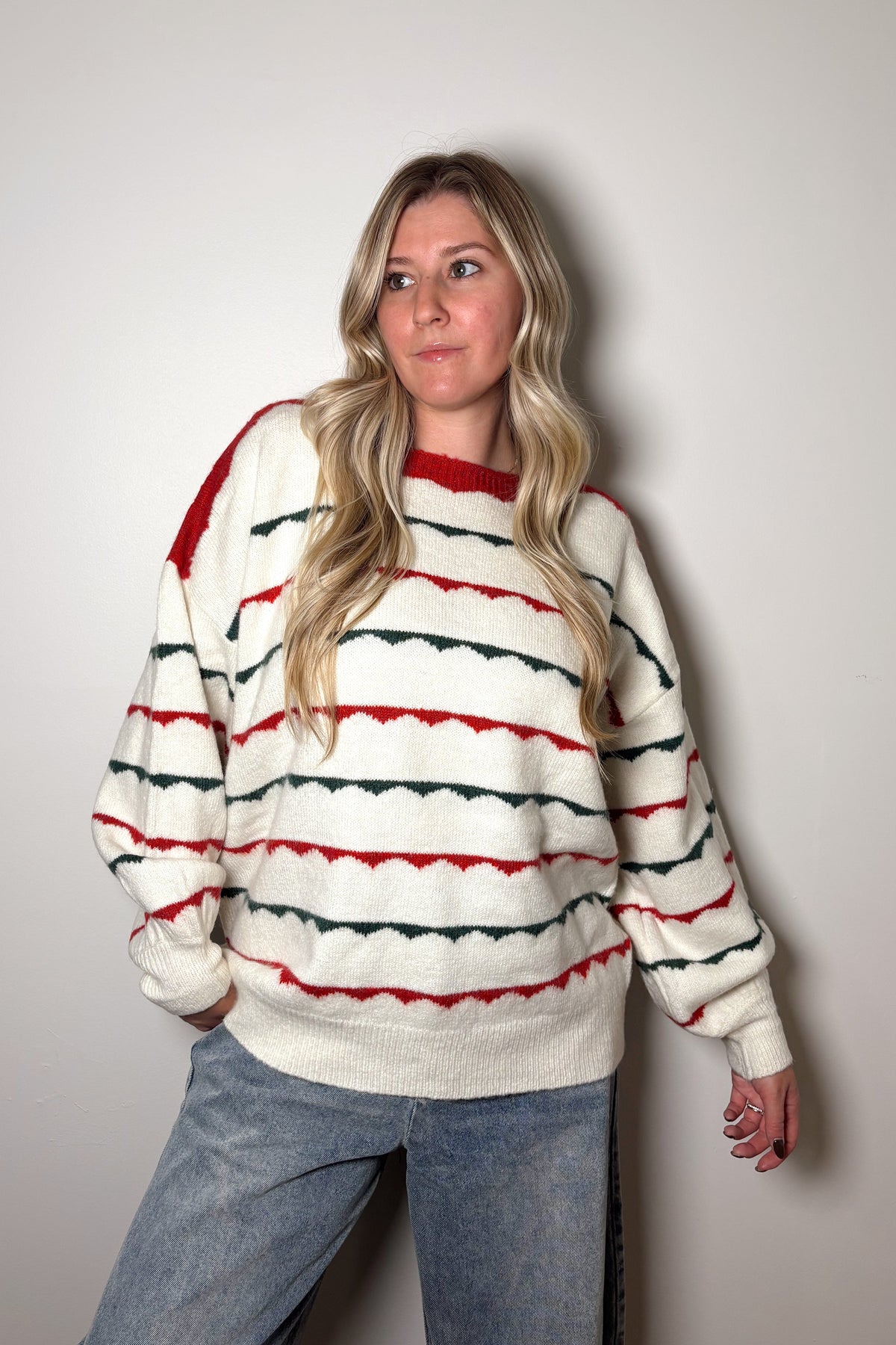 Person wearing a striped sweater against a plain background