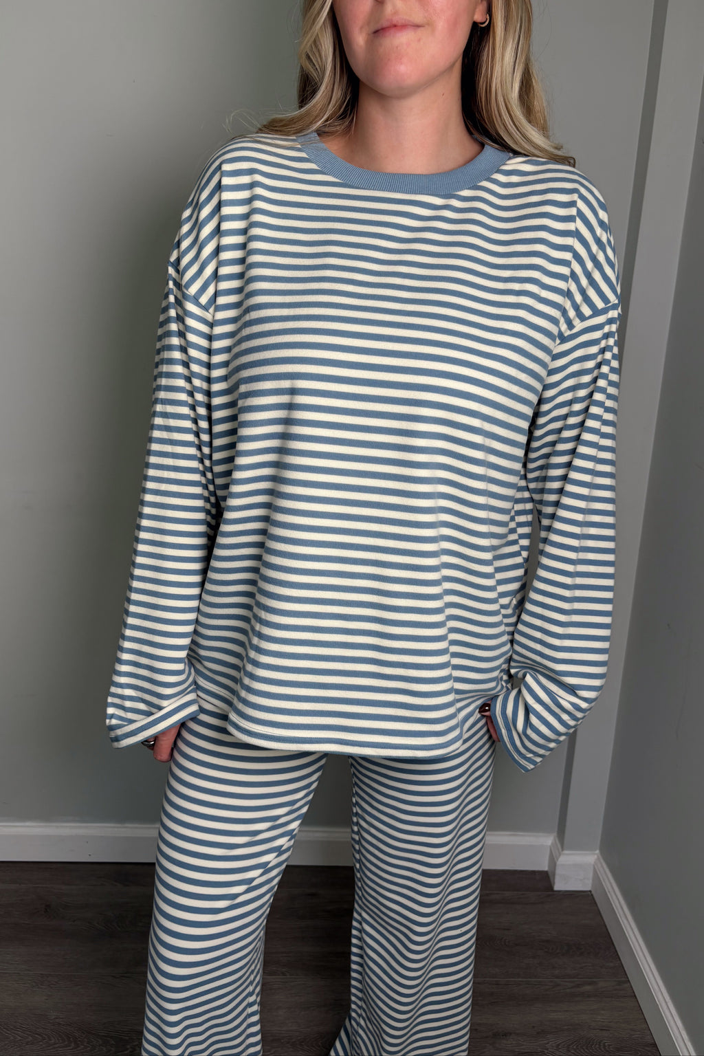 Close-up of the blue Blair lounge set top showing the contrast ribbed crew neckline and striped jersey knit