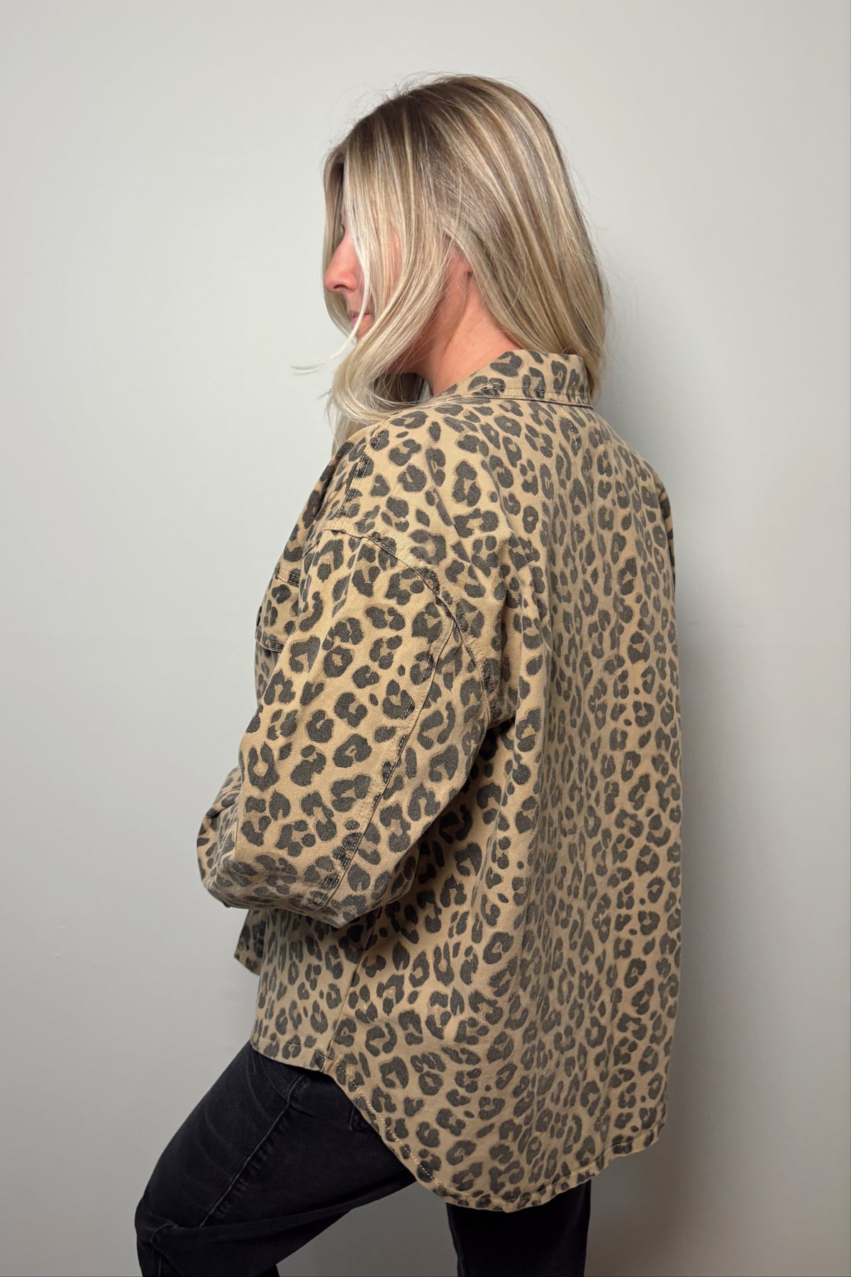 Side and back view of the Wild Muse leopard print shacket showing its loose silhouette and curved hem.


