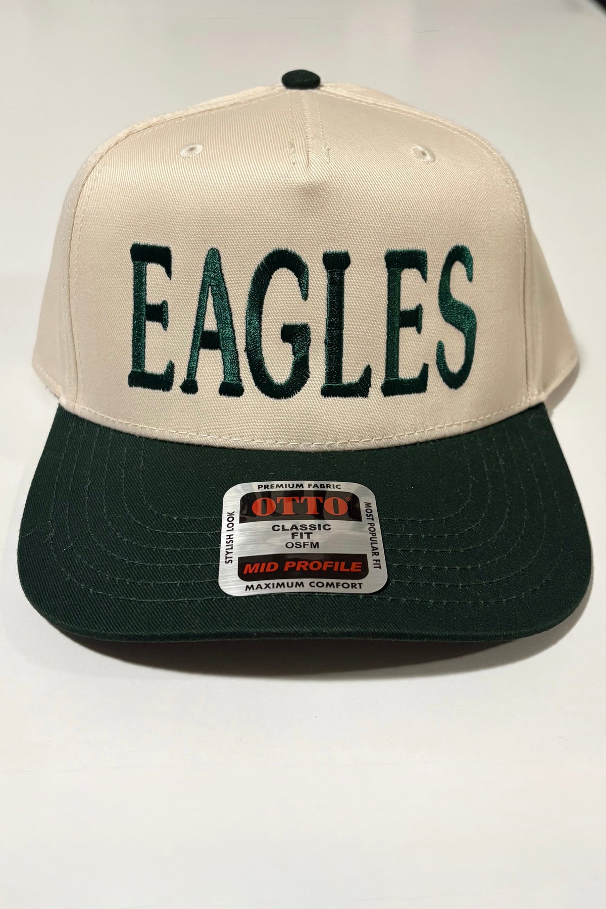 Cream Eagles hat with deep green embroidered lettering and a matching green bill