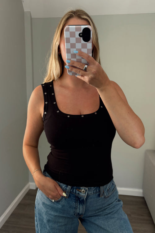 Front view of black ribbed tank showing stud trim along the neckline and straps