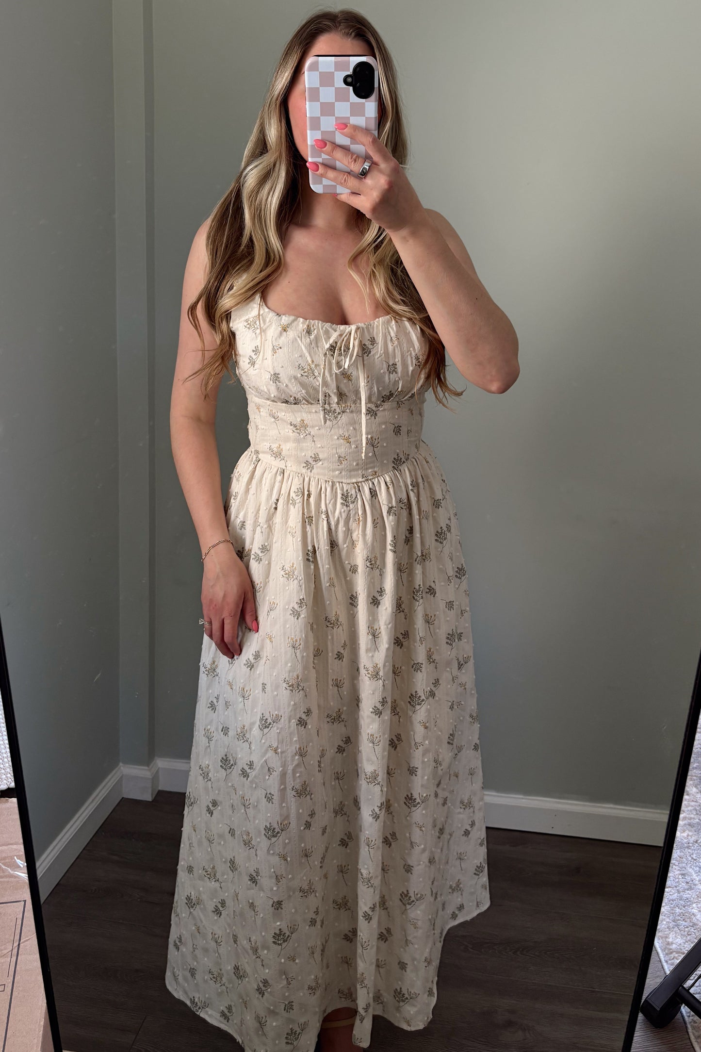 person wearing a floral embroidered maxi dress in a mirror photo