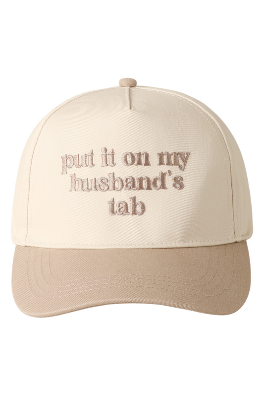 Beige cap with text 'put it on my husband's tab' on a white background