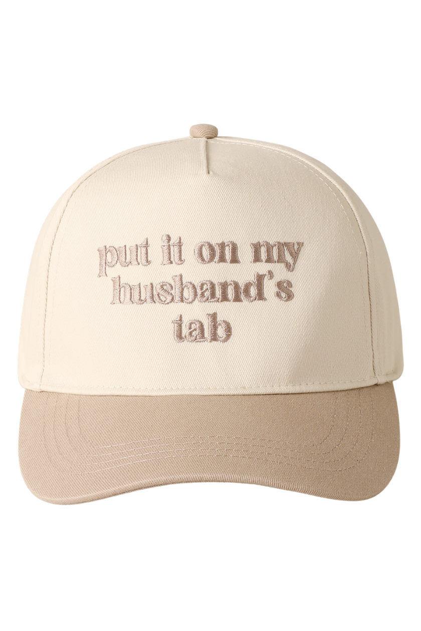 Beige cap with text 'put it on my husband's tab' on a white background