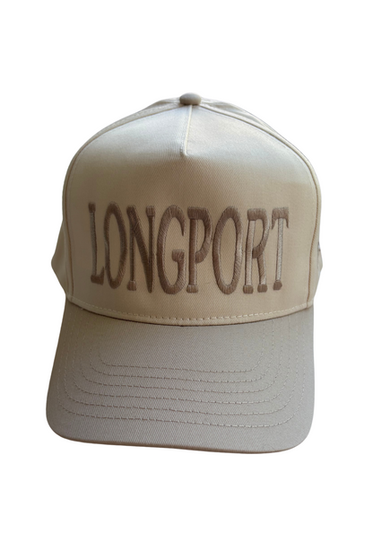 A beige baseball cap with 'LONGPORT' embroidered in brown across the front, shown against a plain white background.