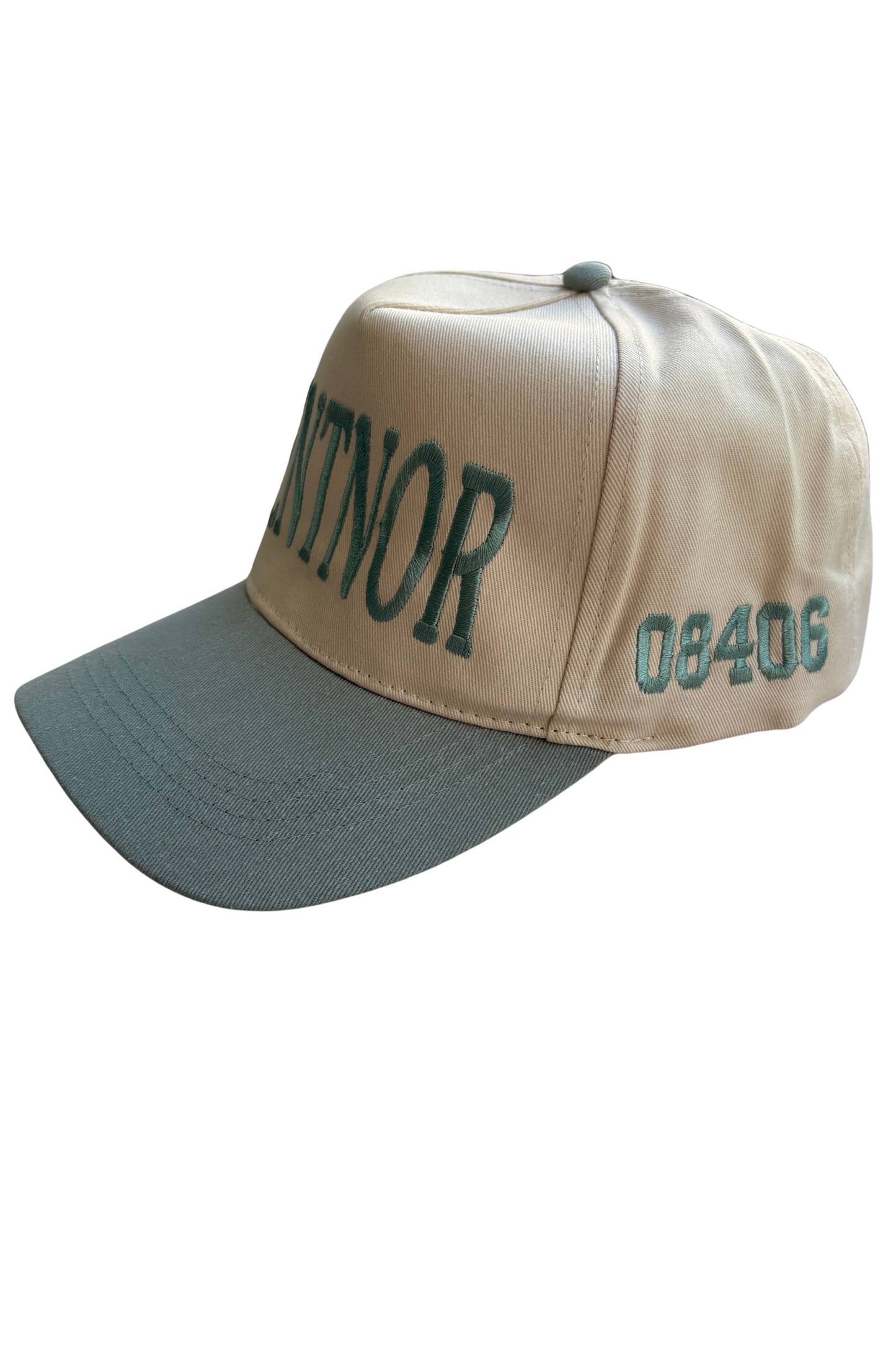A baseball cap with a beige crown and a dark gray brim, featuring green embroidered text 'CANTOR' and the number '08406' on the front and side.