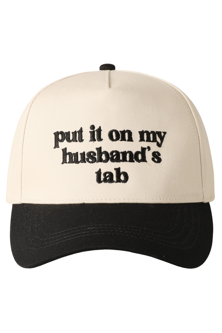Beige and black cap with text 'put it on my husband's tab' on a white background