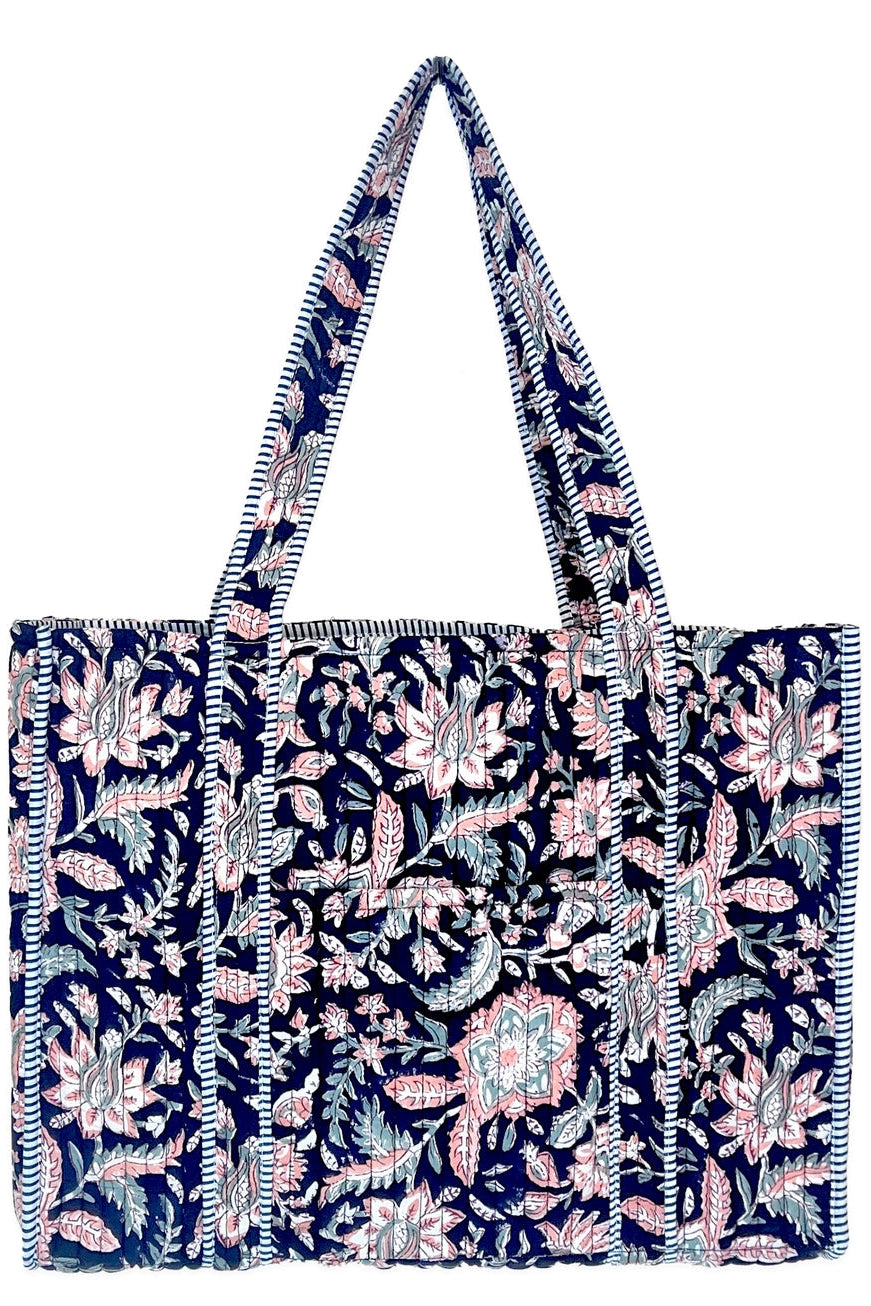 Midnight Desert navy quilted tote bag with pink and pale teal florals, striped trim, and long shoulder straps