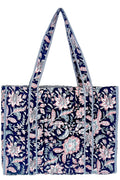 Midnight Desert navy quilted tote bag with pink and pale teal florals, striped trim, and long shoulder straps