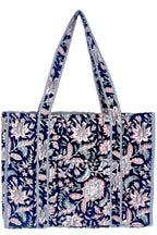 Midnight Desert navy quilted tote bag with pink and pale teal florals, striped trim, and long shoulder straps